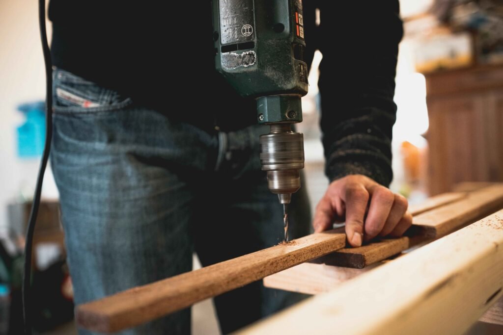 Craftsman carving wood with fine detail tools.