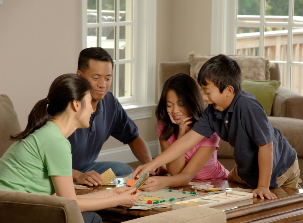 Family laughing around a custom game night.